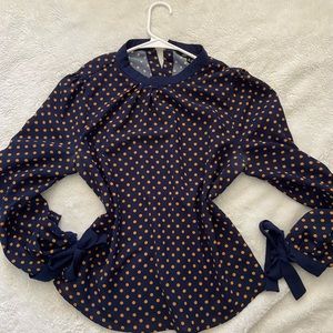 Polka dot blouse. Button down in the back.